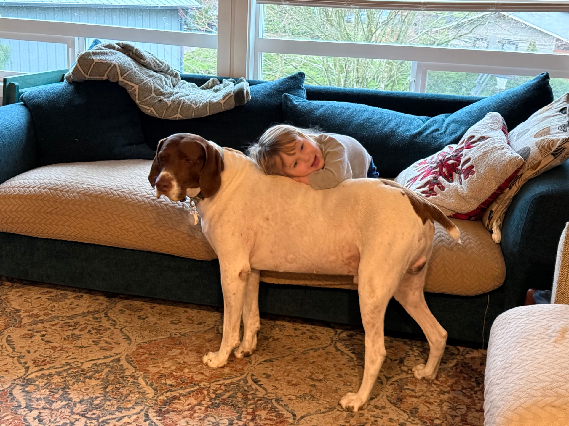 Domenica’s young son resting his head on Eddy at home